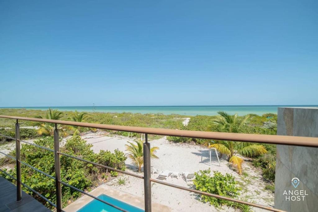 a balcony with a view of the beach at Beachfront Villas with Private Pool Steps to the Sea! in Chicxulub