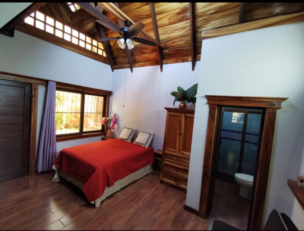 a bedroom with a bed and a ceiling fan at PEDACITO DE CIELO in Santiago Atitlán