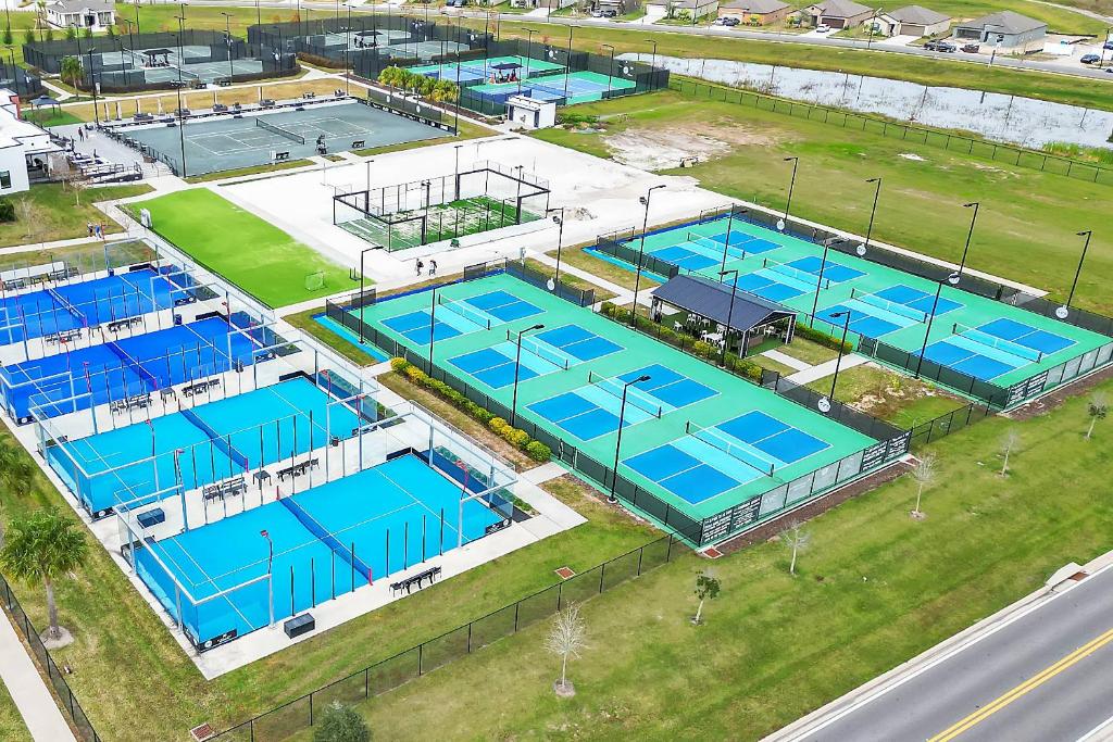 an overhead view of four tennis courts in a building at The Well #303 in Zephyrhills