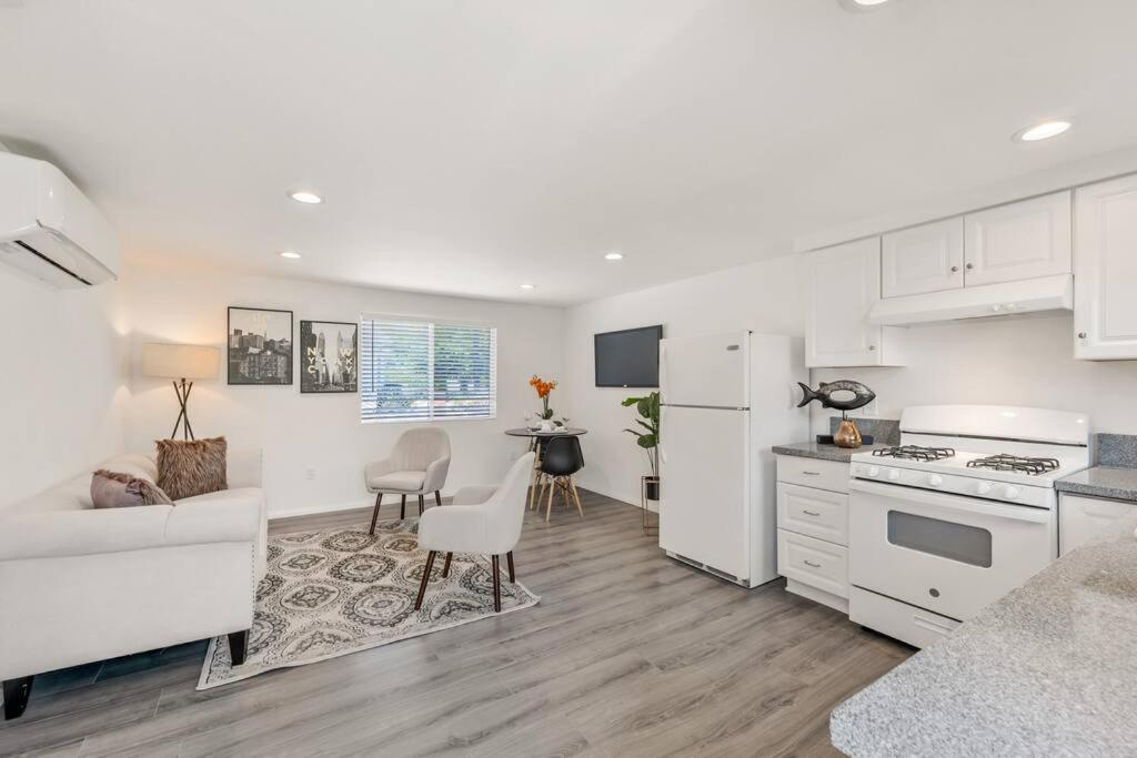 a kitchen and living room with a couch and a table at Modern 1-Bedroom Home in a Prime LA Location in Los Angeles