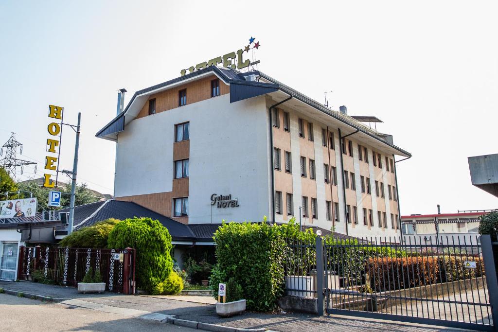 a hotel building with a fence in front of it at Hotel Galant in Venaria Reale