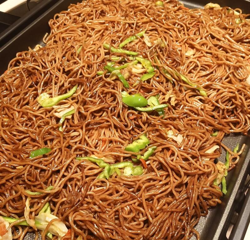 a tray filled with noodles and green broccoli at Iroha Grand Hotel Kintetsu Nara Ekimae in Nara