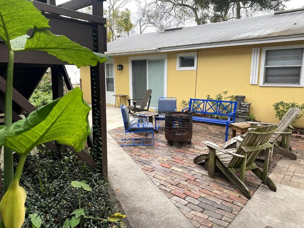 a patio with chairs and a grill and a house at Kid and Pet friendly Downtown Home Walk Everywhere in St. Augustine