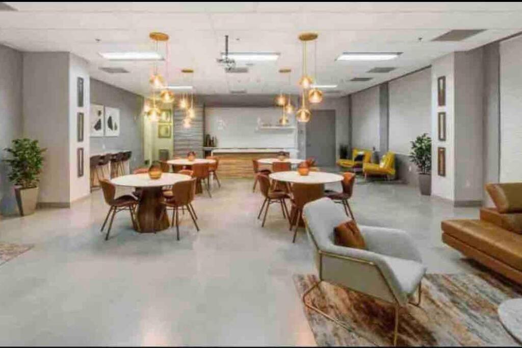 a large room with tables and chairs and a couch at Stunning 1 BDR 1 BTH • Brickell • Bay & City Views in Miami