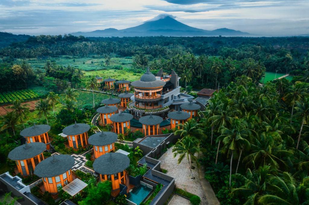 an aerial view of a resort with a mountain in the background at Hotel Le Temple Borobudur in Borobudur