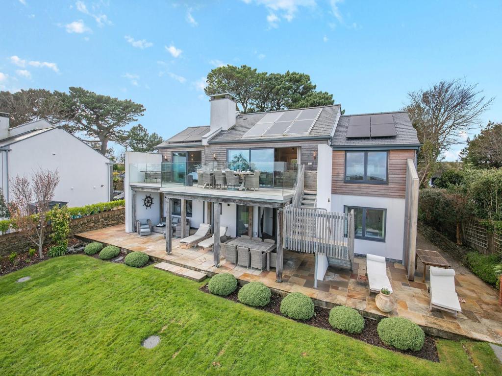 a home with a deck and a house at Long Commons in Saint Mawes