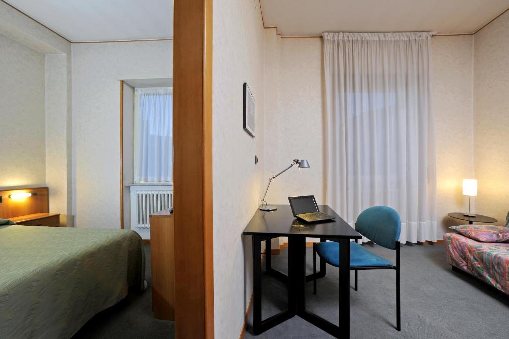 Postel nebo postele na pokoji v ubytování Tuscia Hotel