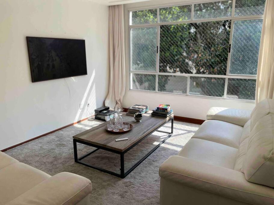a living room with a couch and a coffee table at Apartamento Orla Praia do Canto in Vitória