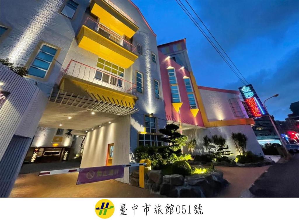 a building with neon signs on the side of it at Jinsha Motel in Taichung