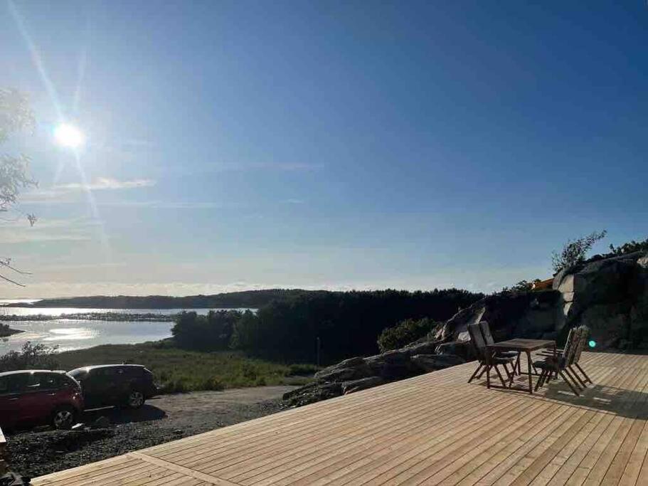 a deck with chairs and a view of a lake at Sea side villa with breathtaking view in Gothenburg
