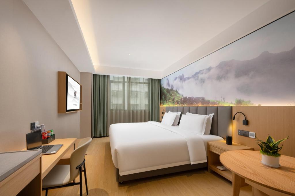 Ένα ή περισσότερα κρεβάτια σε δωμάτιο στο True Go Hotel - Shenzhen Futian Huaqiang North