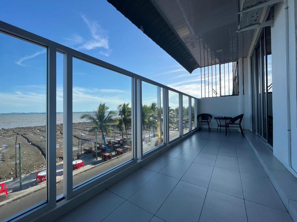 a view of the beach from the balcony of a building at Homestay Tawau With Seaview. Anekayangan Homestay in Tawau