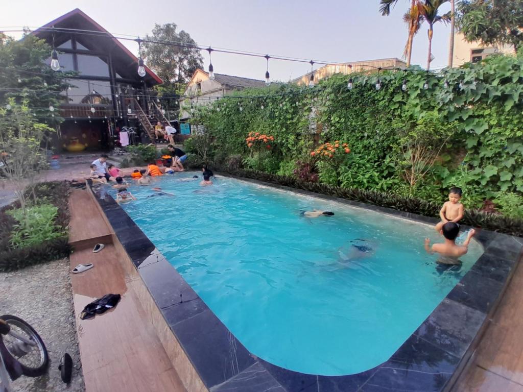 a group of people swimming in a swimming pool at 1989 Villa in Việt Trì