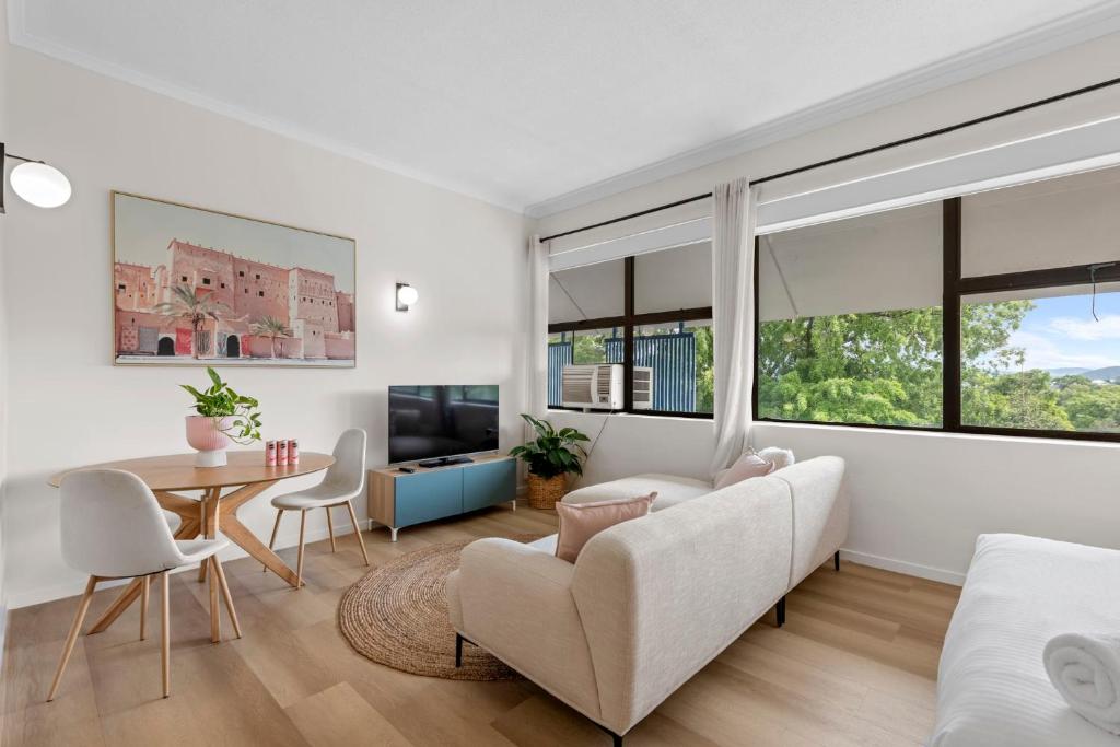a living room with a couch and a table at Urban Chic Brisbane Retreat in Brisbane