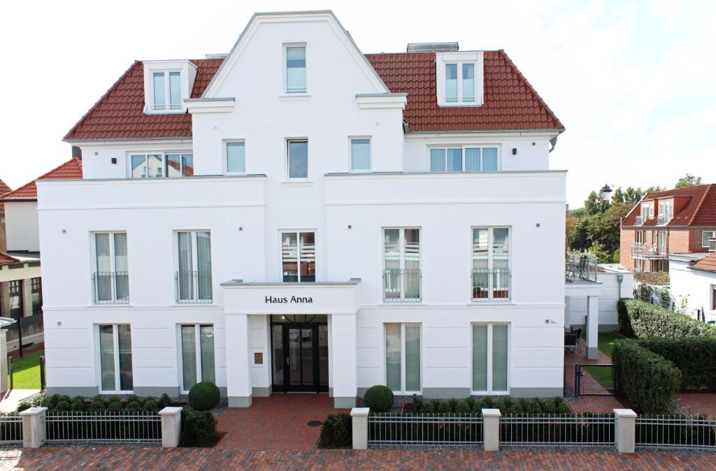 a white house with a sign that reads hassam at Haus Anna - Wohnung 3 in Wangerooge