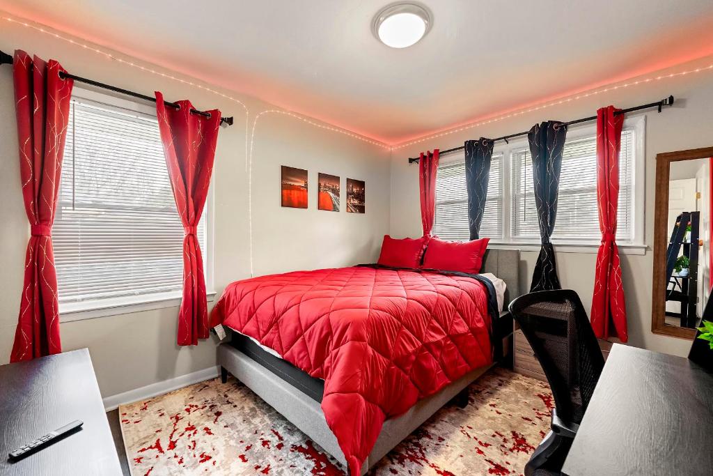 a bedroom with red curtains and a red bed at Rose’s Lair in Atlanta(ATL) Near Downtown/Midtown/MARTA/Hartsfield-Jackson Airport in Atlanta