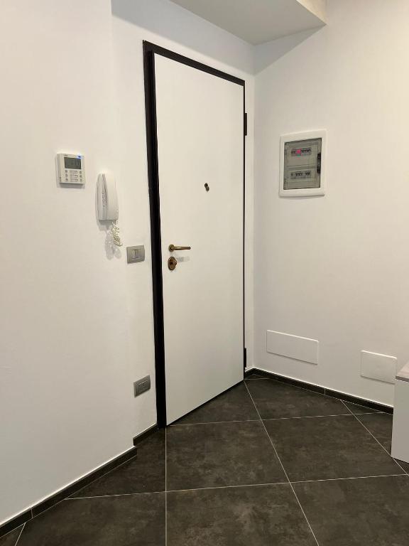 eine weiße Tür in einem Zimmer mit Fliesenboden in der Unterkunft Appartamento clarissa in Alassio