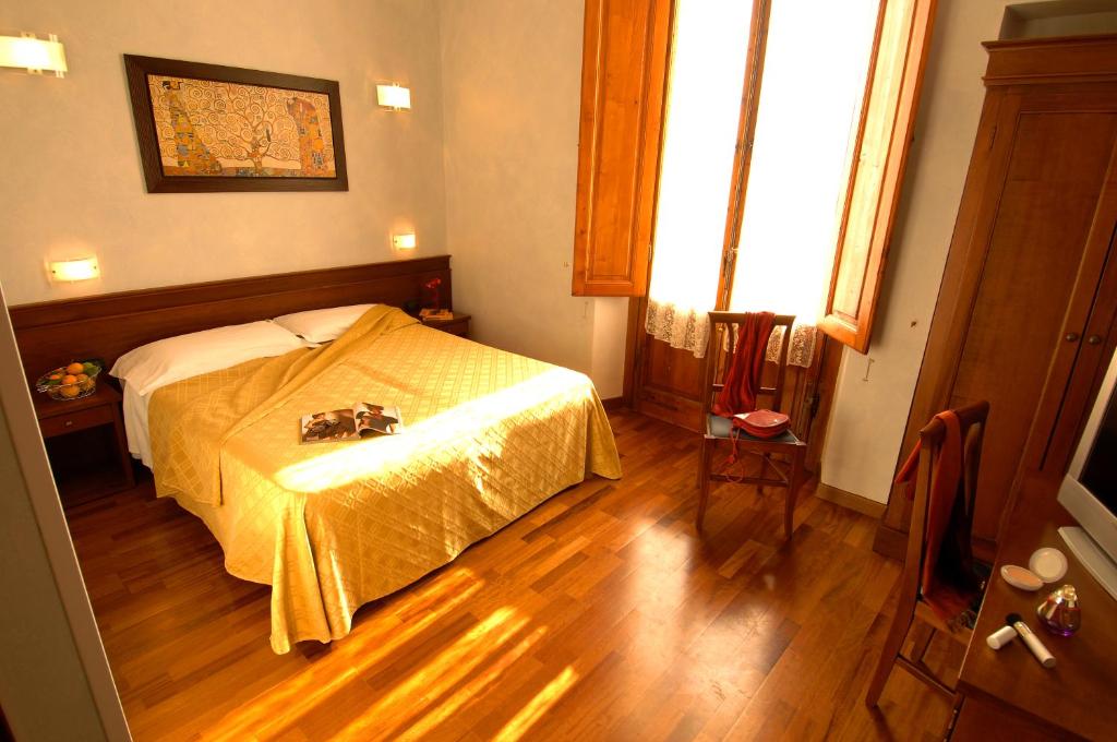 Postel nebo postele na pokoji v ubytování Hotel Palazzo Vecchio