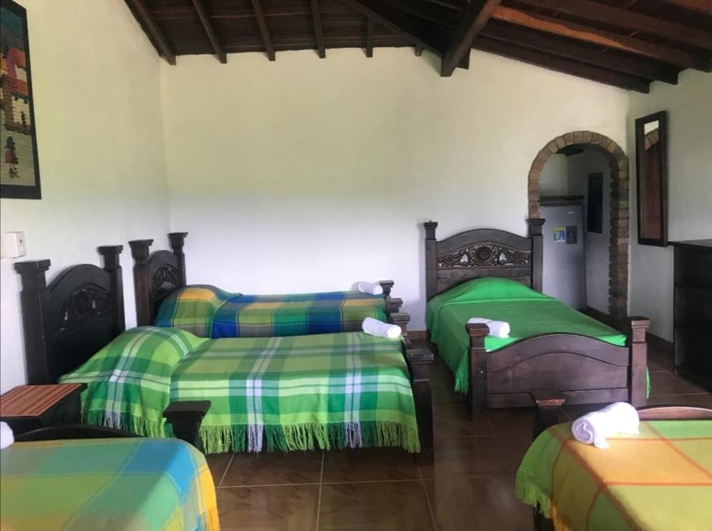 A bed or beds in a room at Hotel Campestre capilla del Pienta