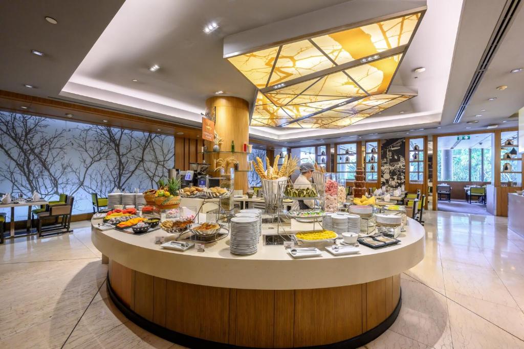 A circular buffet station in a bright hotel dining room.