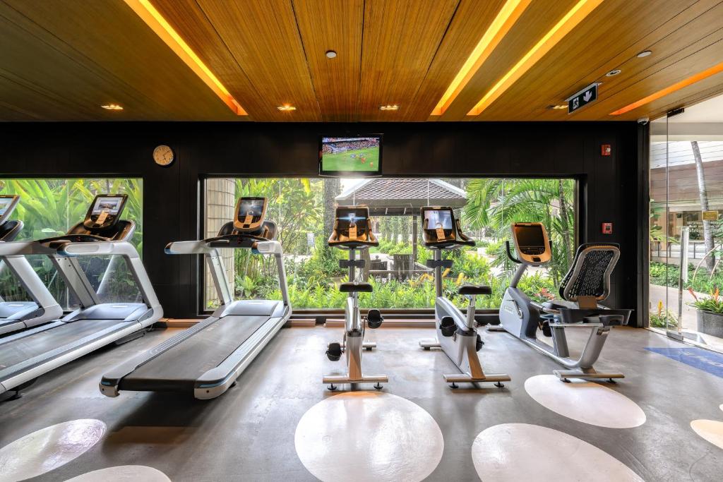 A bright cardio corner overlooking landscaped greenery.