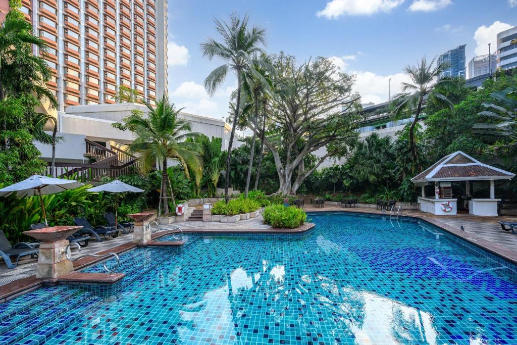 a large swimming pool in the middle of a city at Centara Grand at Central Plaza Ladprao Bangkok in Bangkok