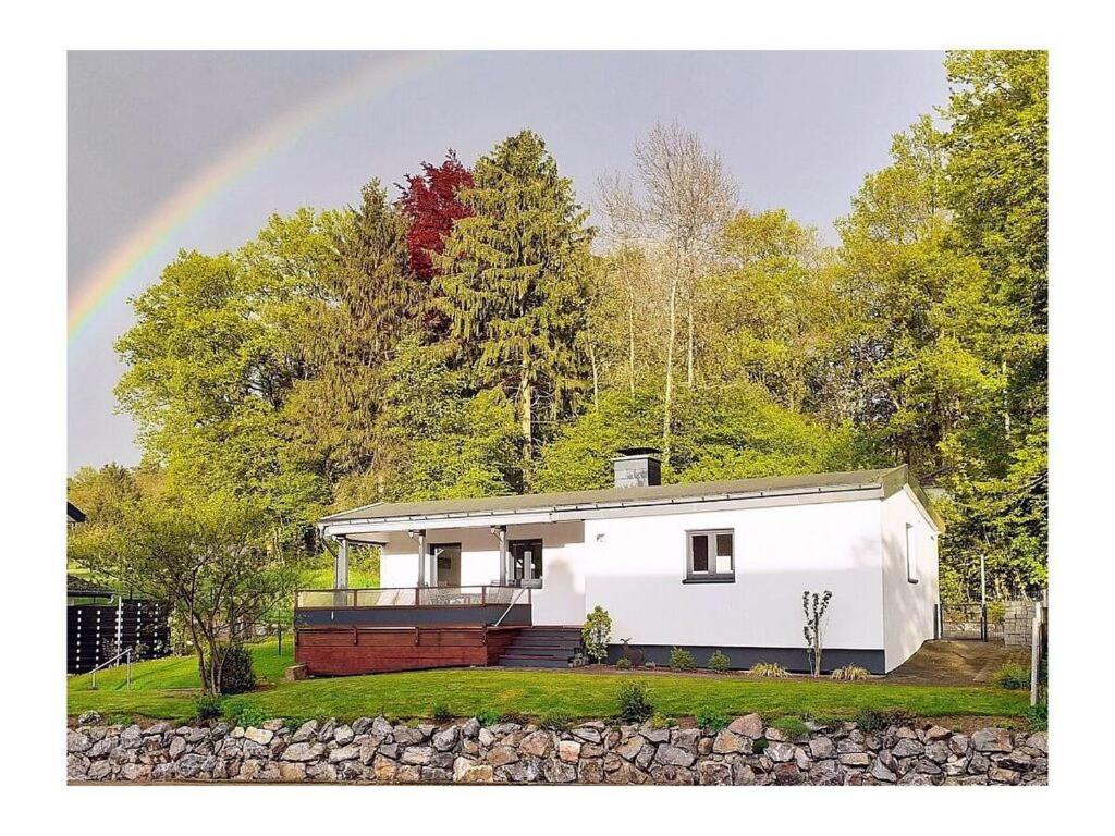 a white house with a rainbow in the background at Wamel Modern retreat in Möhnesee