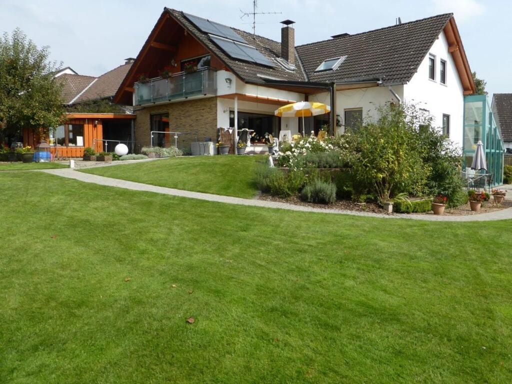 a house with a green lawn in front of it at "Weserbergland" Modern retreat in Beverungen