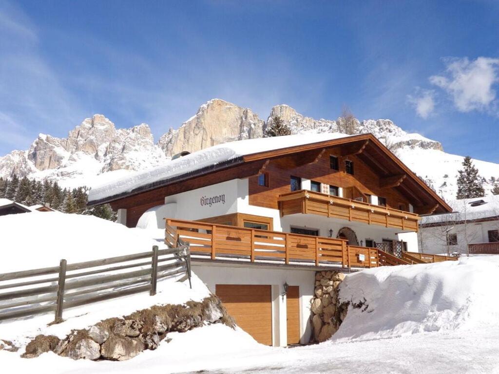 a house in the mountains with snow on the ground at Columbine Modern Retreat in Carezza al Lago