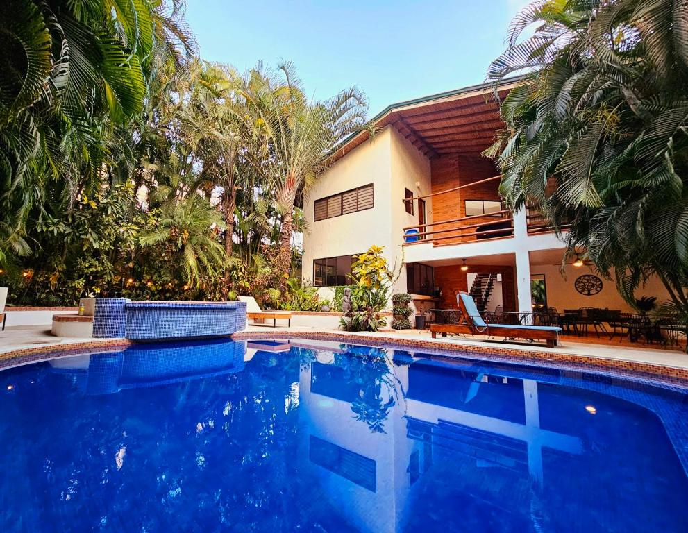 a swimming pool in front of a house at Dreamcatcher Hotel - Atrapasueños in Santa Teresa Beach