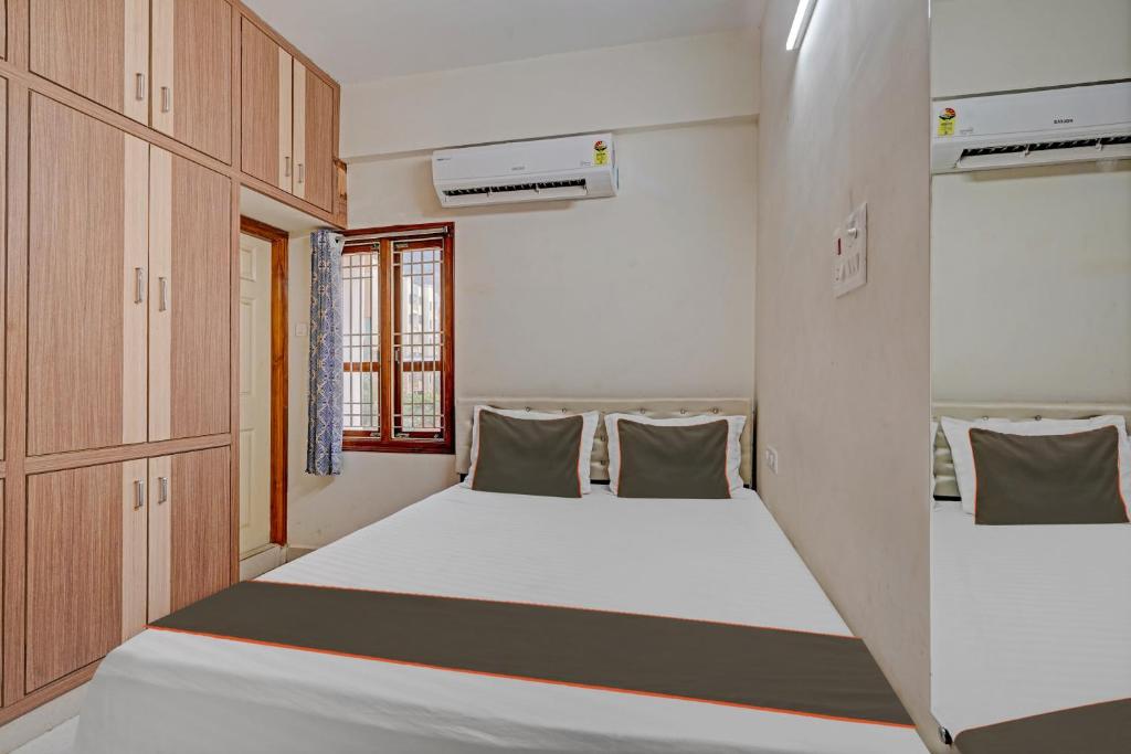 a small room with two beds in it at Collection O Ns Service Apartment in Tirupati