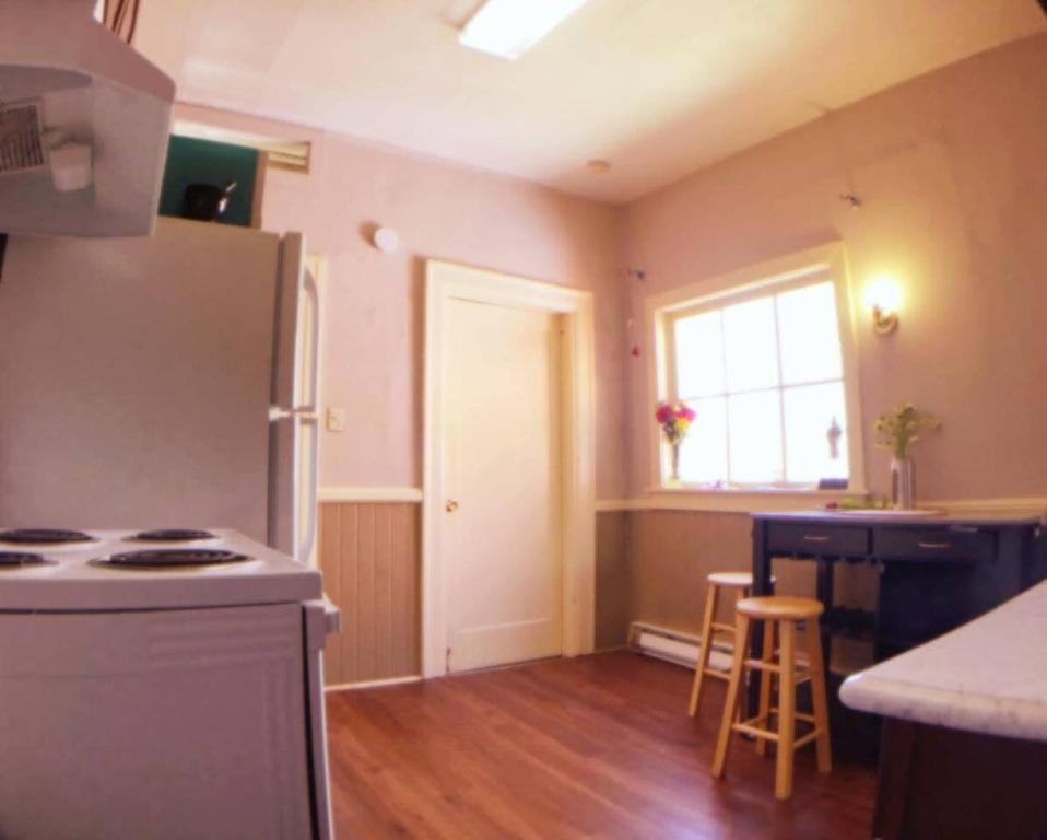 a kitchen with a stove and a refrigerator and a window at A-Capital Hill Hideaway in Seattle