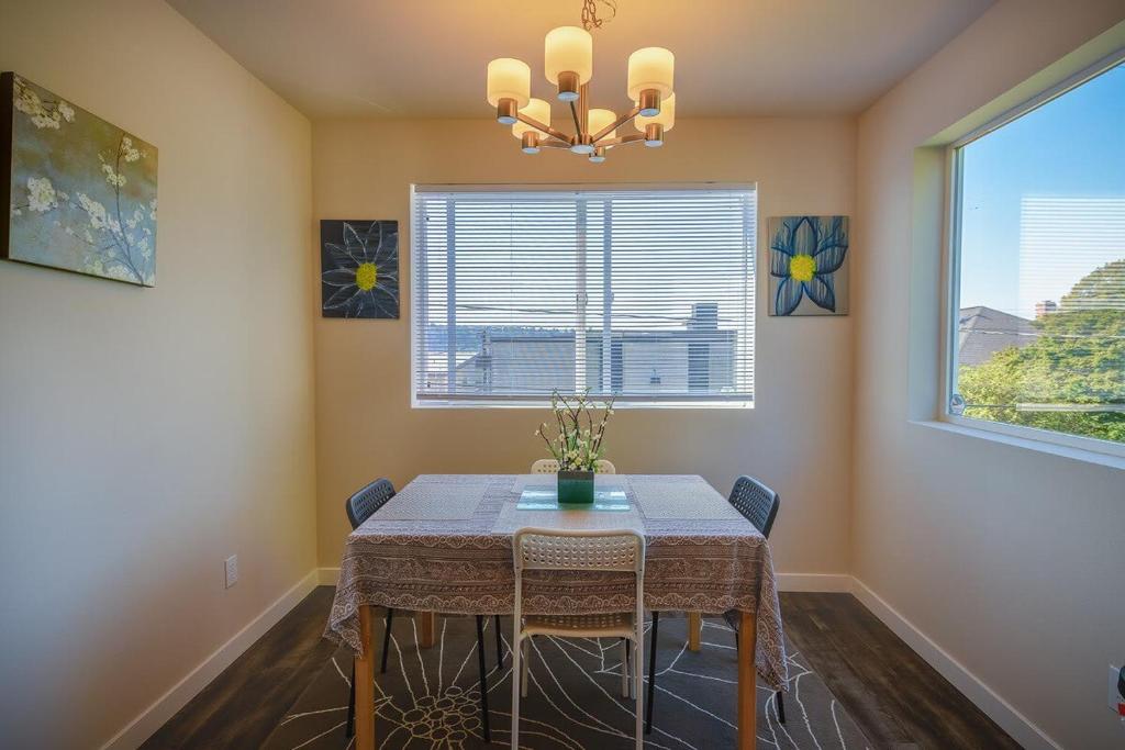 a dining room with a table and two windows at Seattle Urban Village- San Juan- Roof top view deck in Seattle