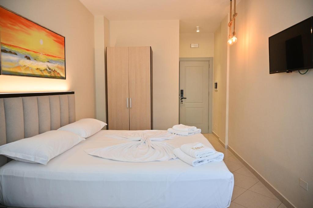 Uma cama ou camas num quarto em Hotel Zanzi