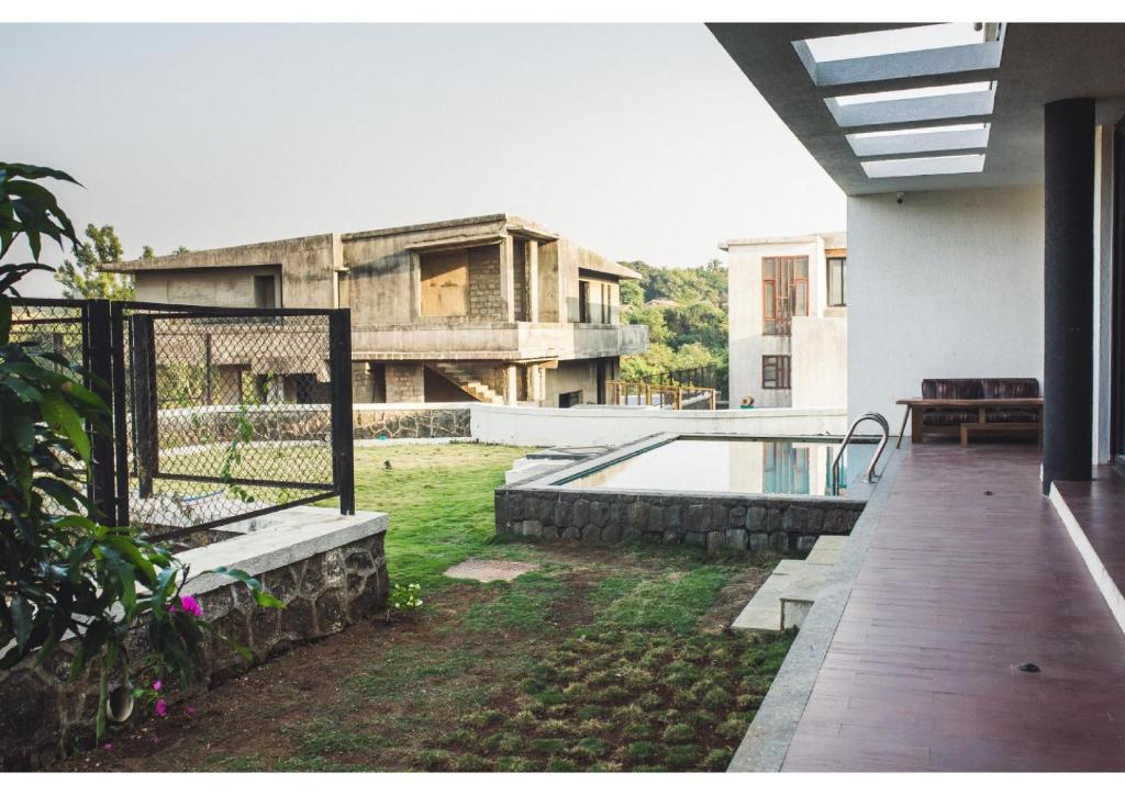 a house with a swimming pool in the yard at Aspire villa 30 in Lonavala