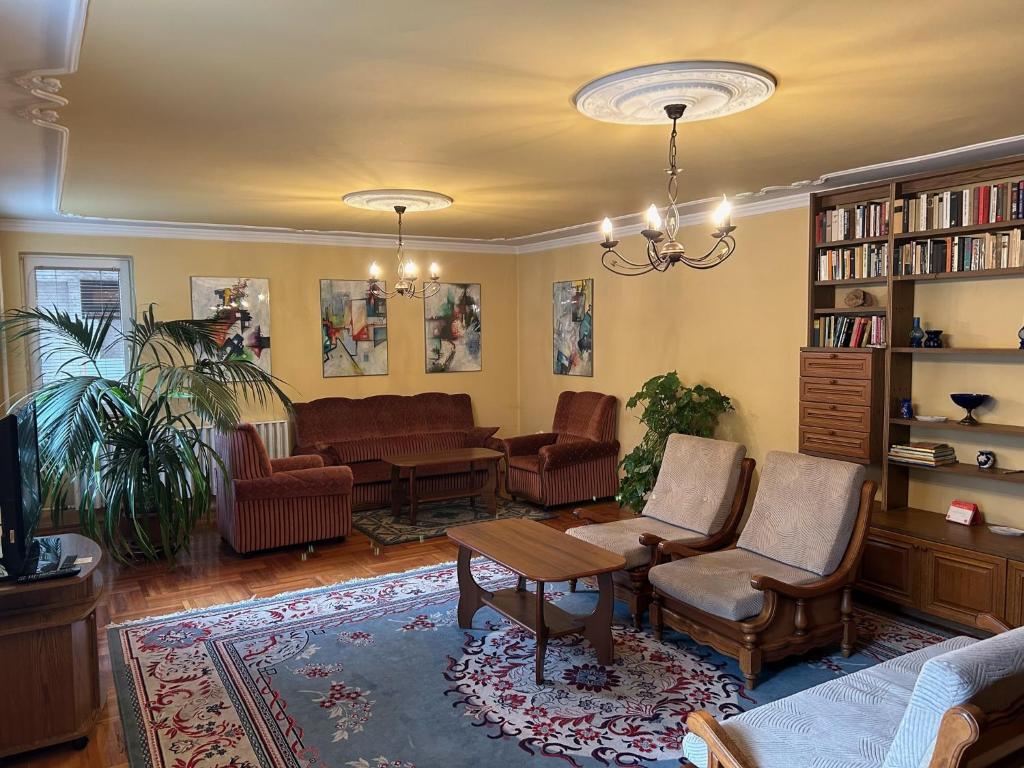 a living room with a couch and a table at Galéria Vendégház in Mezőkövesd