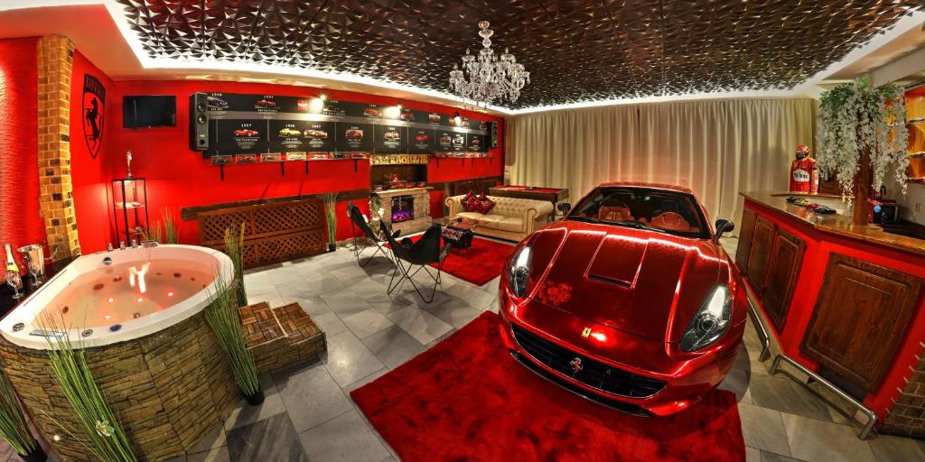 a red car in a room with a bath tub at Ferrari wellness apartmán in Pardubice