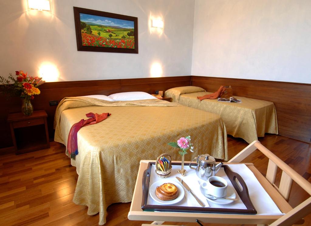 Postel nebo postele na pokoji v ubytování Hotel Palazzo Vecchio