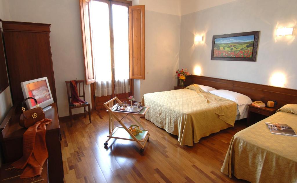 Postel nebo postele na pokoji v ubytování Hotel Palazzo Vecchio
