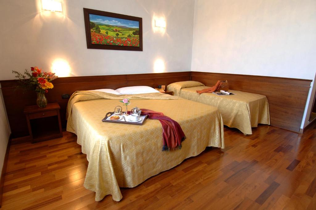 Postel nebo postele na pokoji v ubytování Hotel Palazzo Vecchio