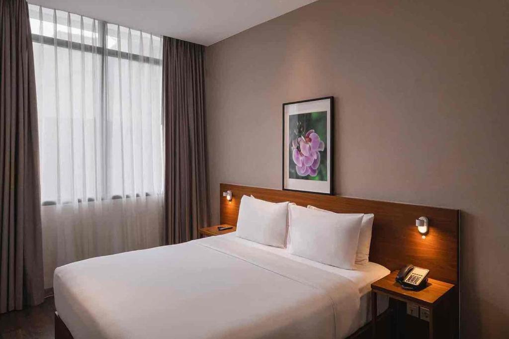 Postel nebo postele na pokoji v ubytování Veranda Serviced Residence Puri