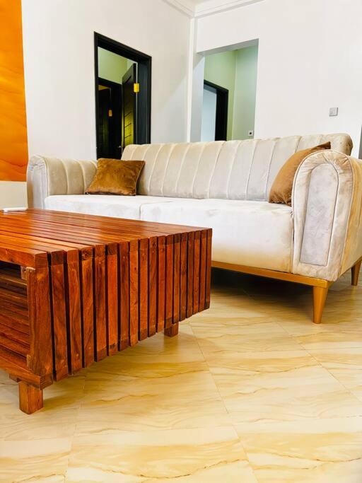 a living room with a couch and a coffee table at Malaika Homes Jinja in Jinja