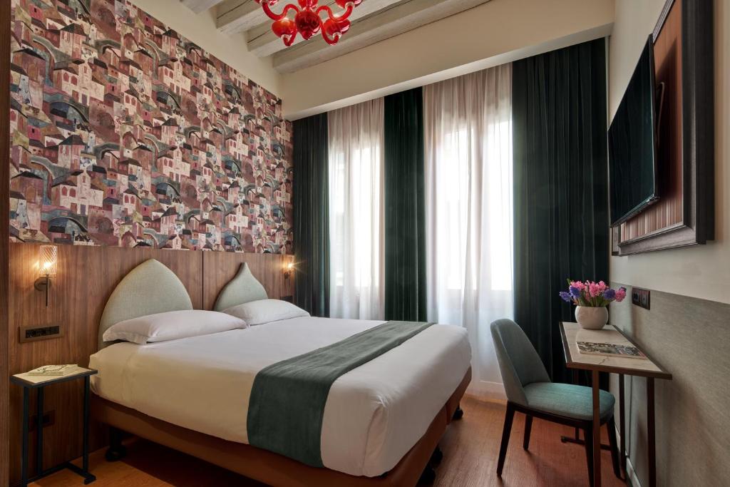 Postel nebo postele na pokoji v ubytování UNAHOTELS Ala Venezia-Adults 16