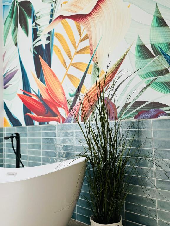 a bathroom with a mural of flowers on the wall at Sievershof Strandbar in Wietzendorf