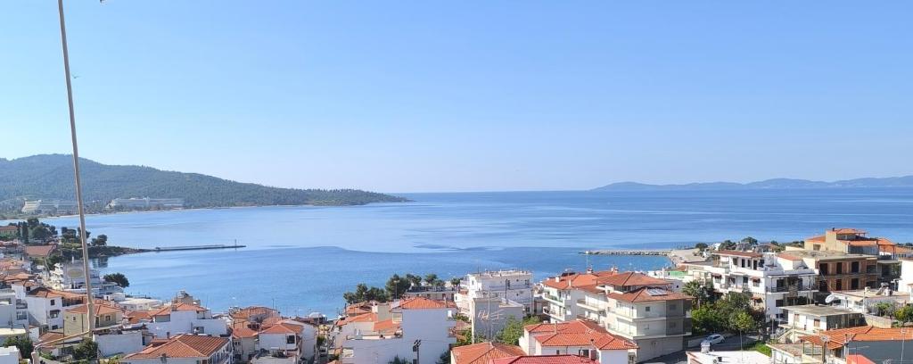 a view of a city and the water at House Mistral in Neos Marmaras