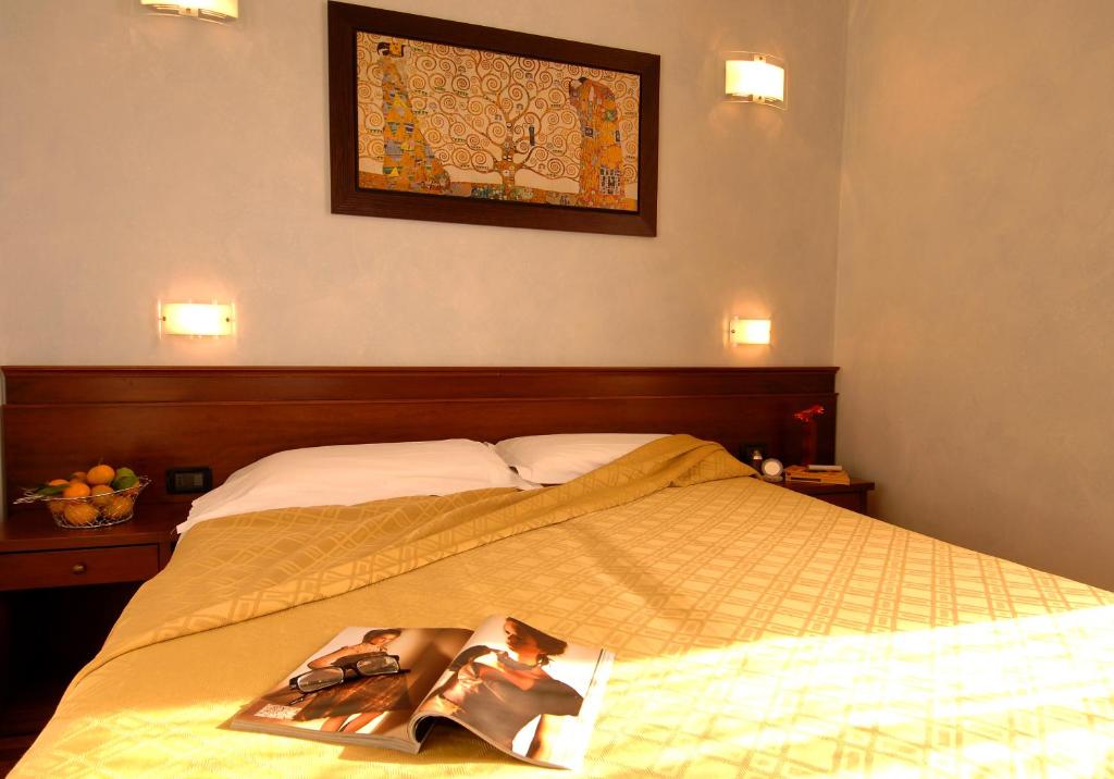 Postel nebo postele na pokoji v ubytování Hotel Palazzo Vecchio