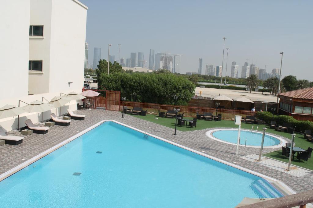 a swimming pool on the roof of a building at Villaggio Hotel Abu Dhabi in Abu Dhabi