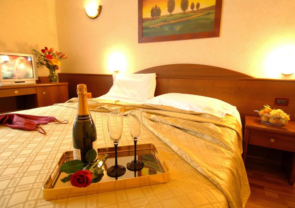 Postel nebo postele na pokoji v ubytování Hotel Palazzo Vecchio