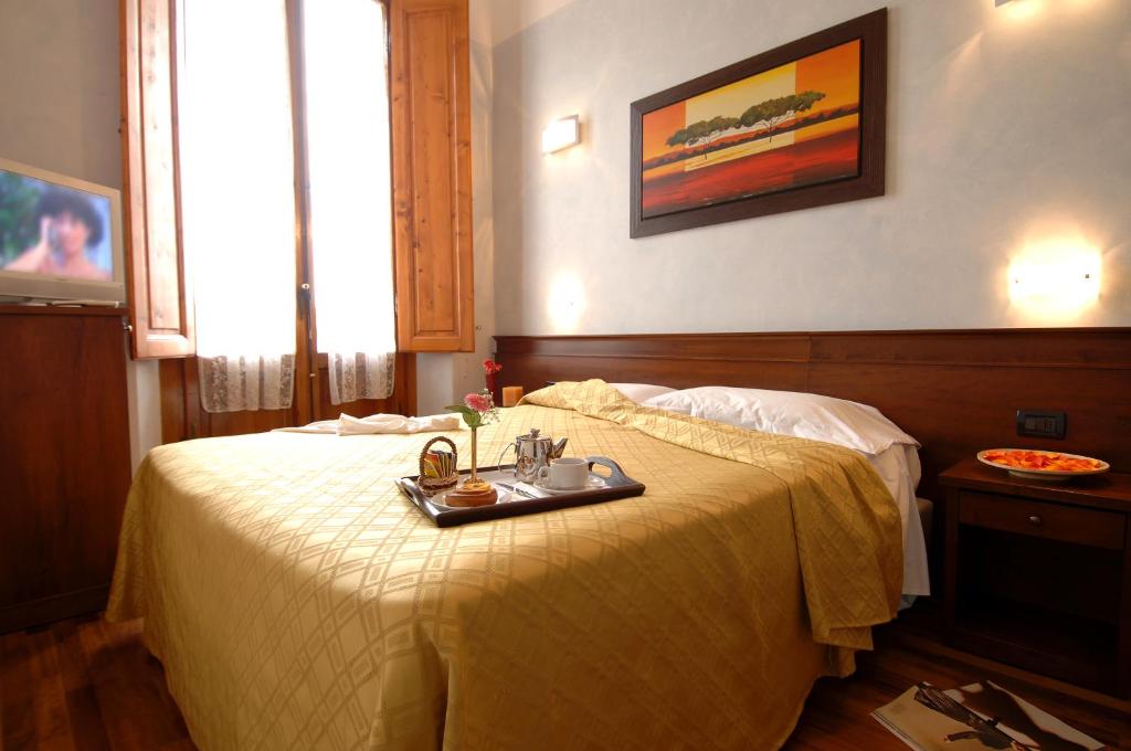 Postel nebo postele na pokoji v ubytování Hotel Palazzo Vecchio