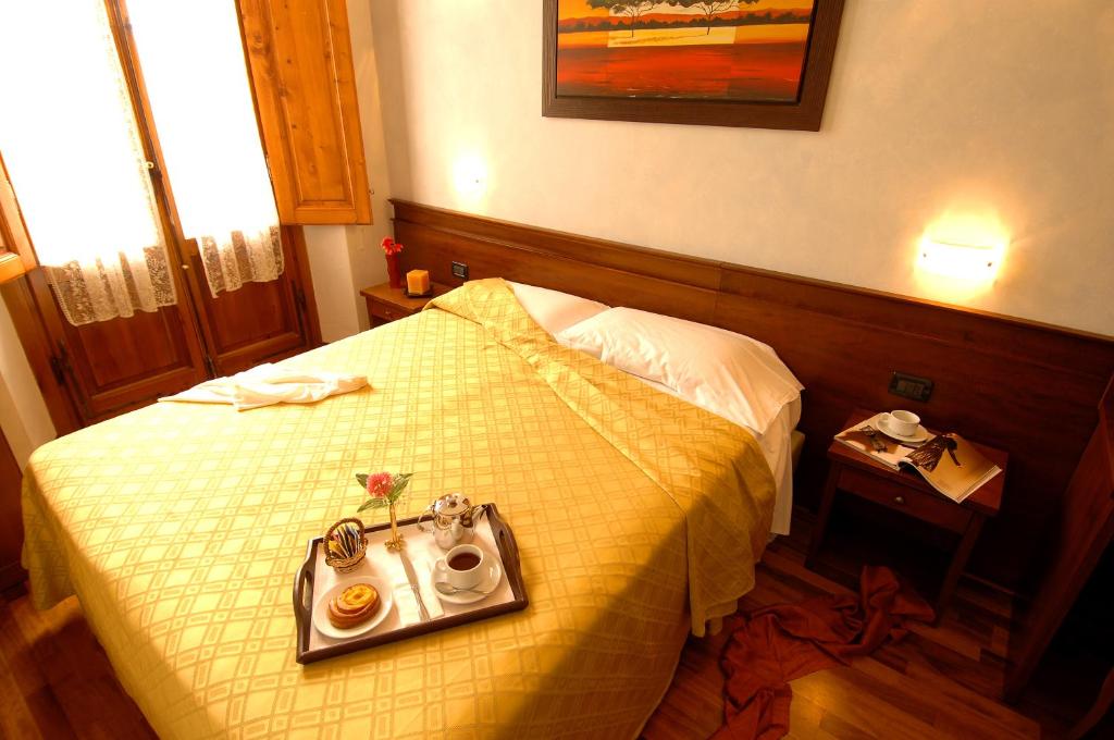 Postel nebo postele na pokoji v ubytování Hotel Palazzo Vecchio